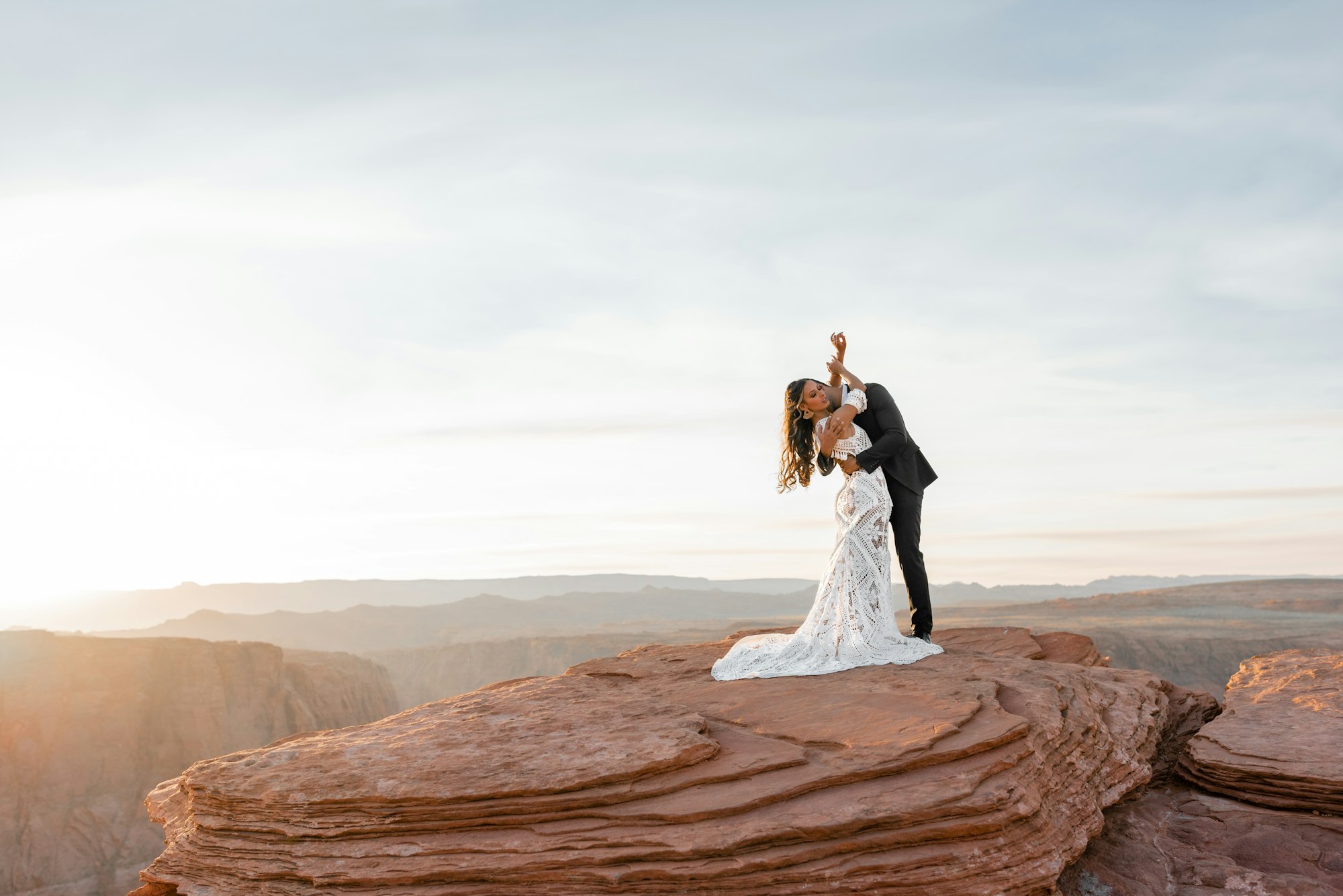 PLACEHOLDER (Unsplash) — couple kissing on a rock formation