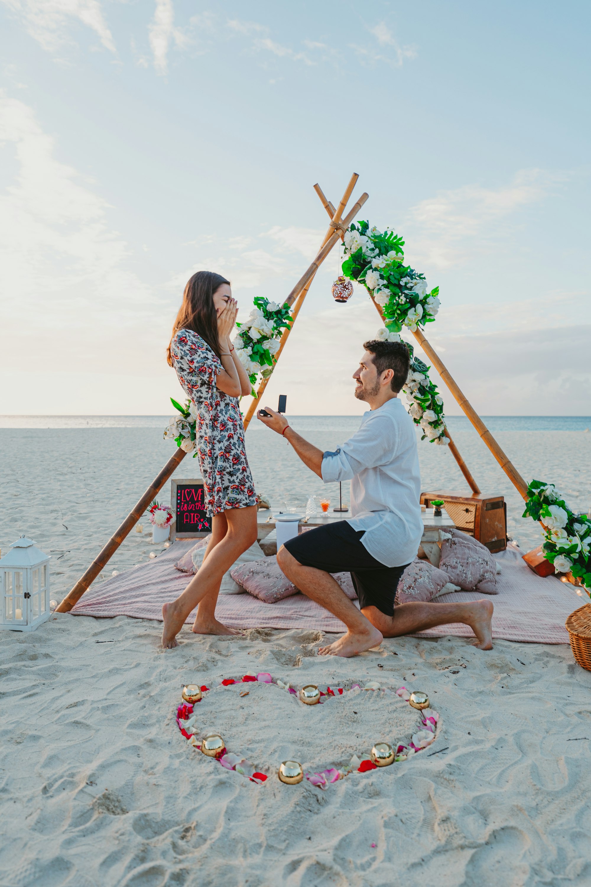 PLACEHOLDER (Unsplash) — proposal on the beach at sunset