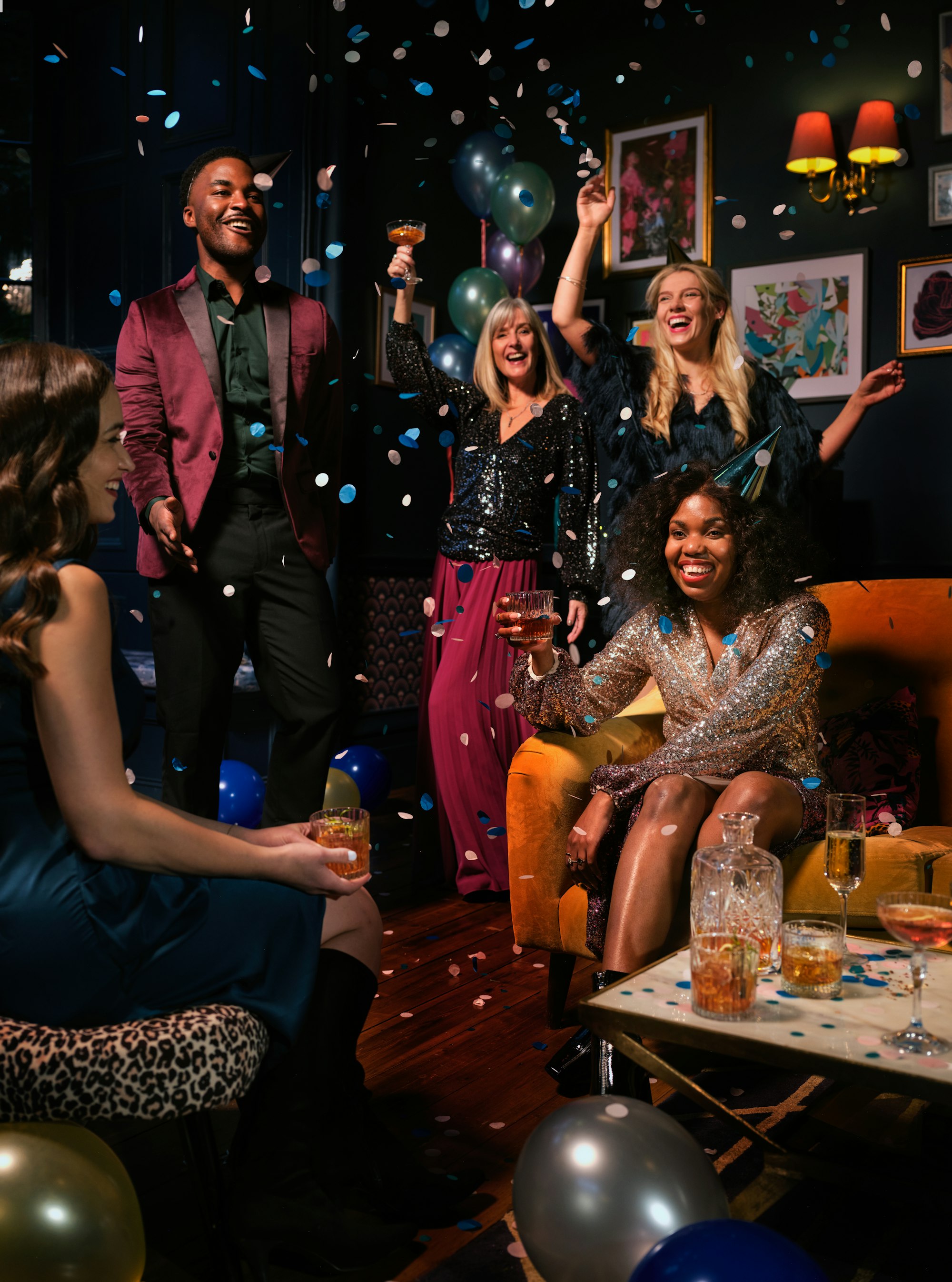 PLACEHOLDER (Unsplash) — group celebrating with confetti and balloons