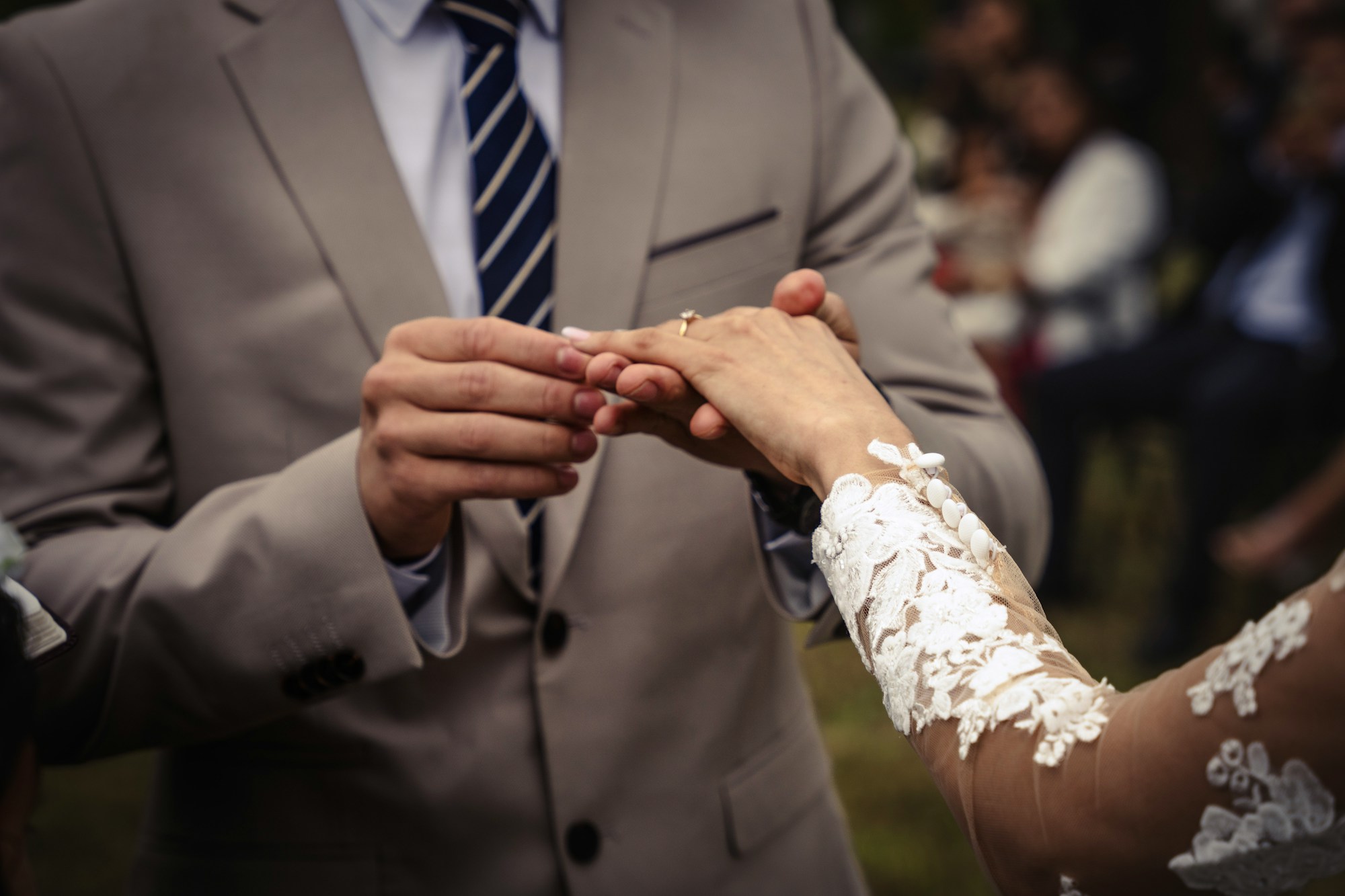 PLACEHOLDER (Unsplash) — bride and groom holding hands during the ceremony