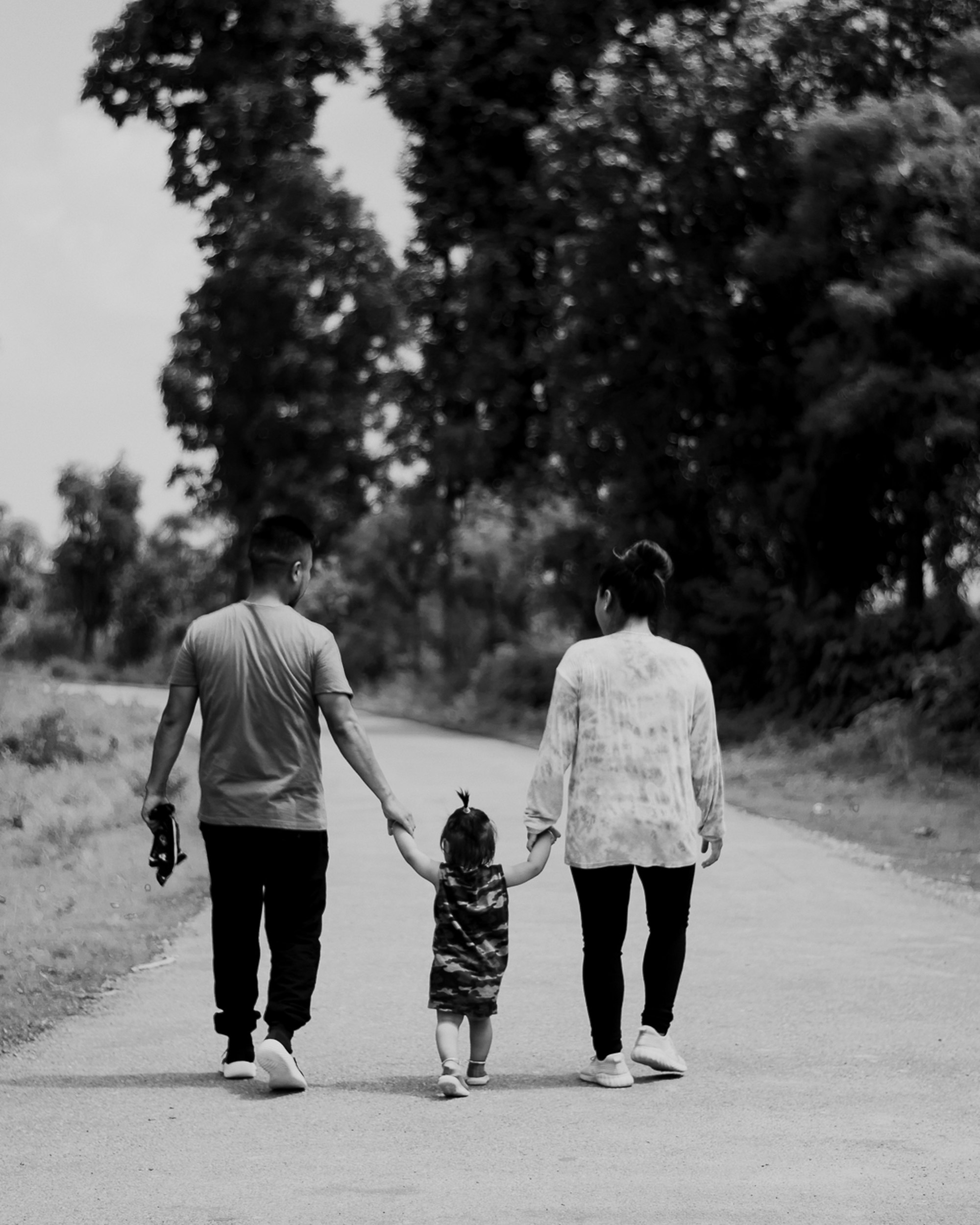 PLACEHOLDER (Unsplash) — couple walking a dog on a road