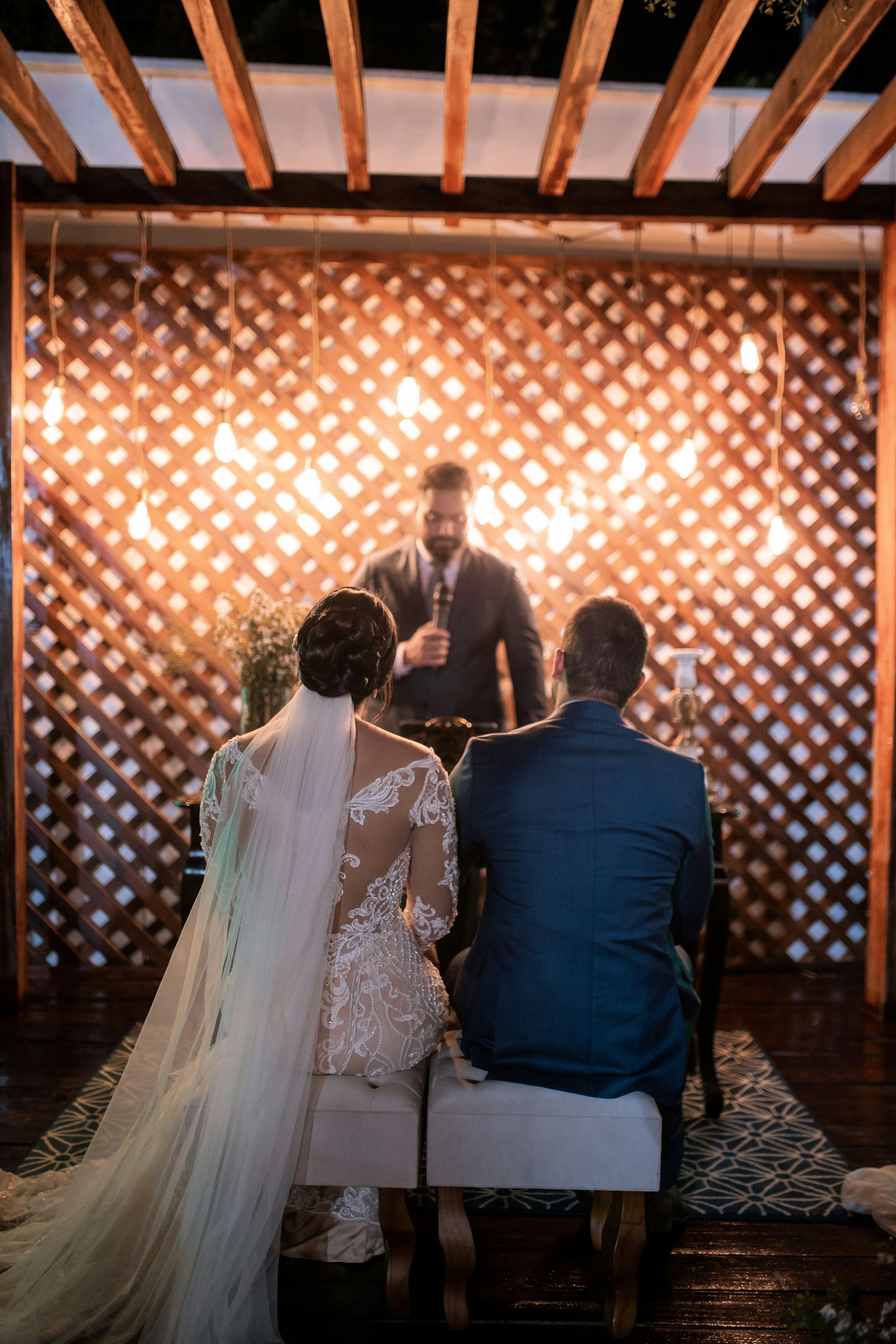 PLACEHOLDER (Unsplash) — bride and groom sitting on a bench during the ceremony