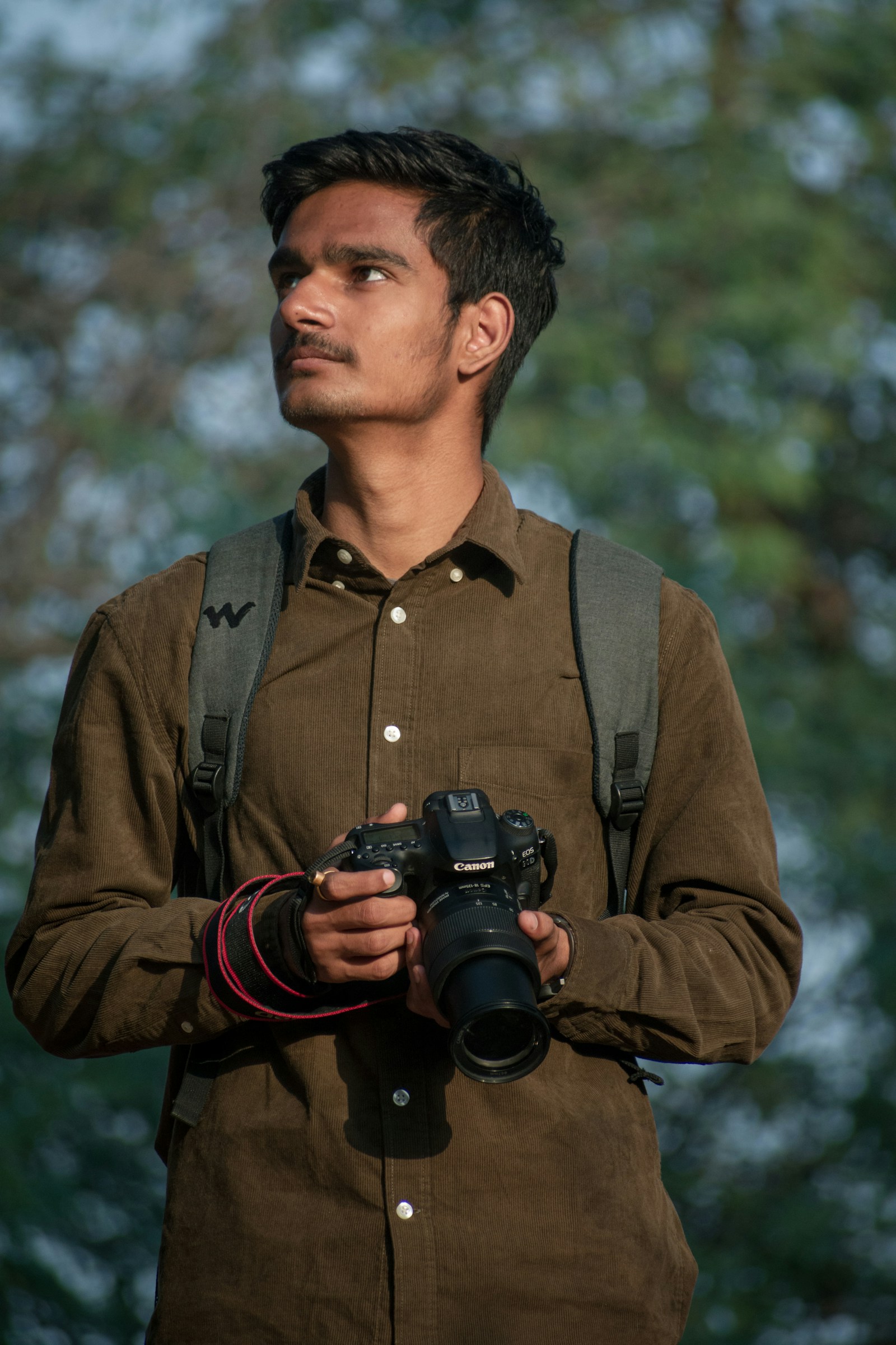 PLACEHOLDER (Unsplash) — photographer holding a camera