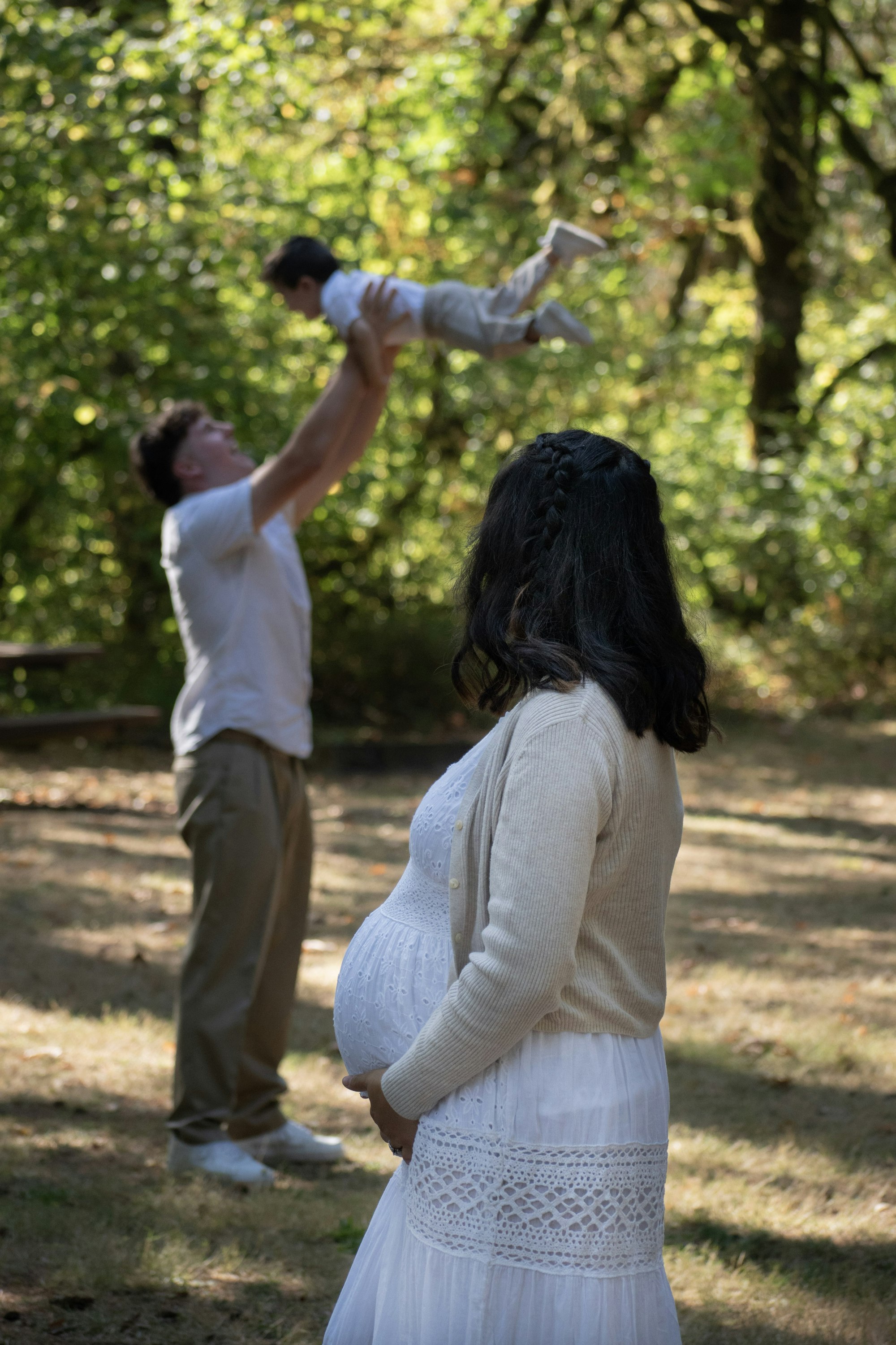 PLACEHOLDER (Unsplash) — father tossing child in the air while mother watches