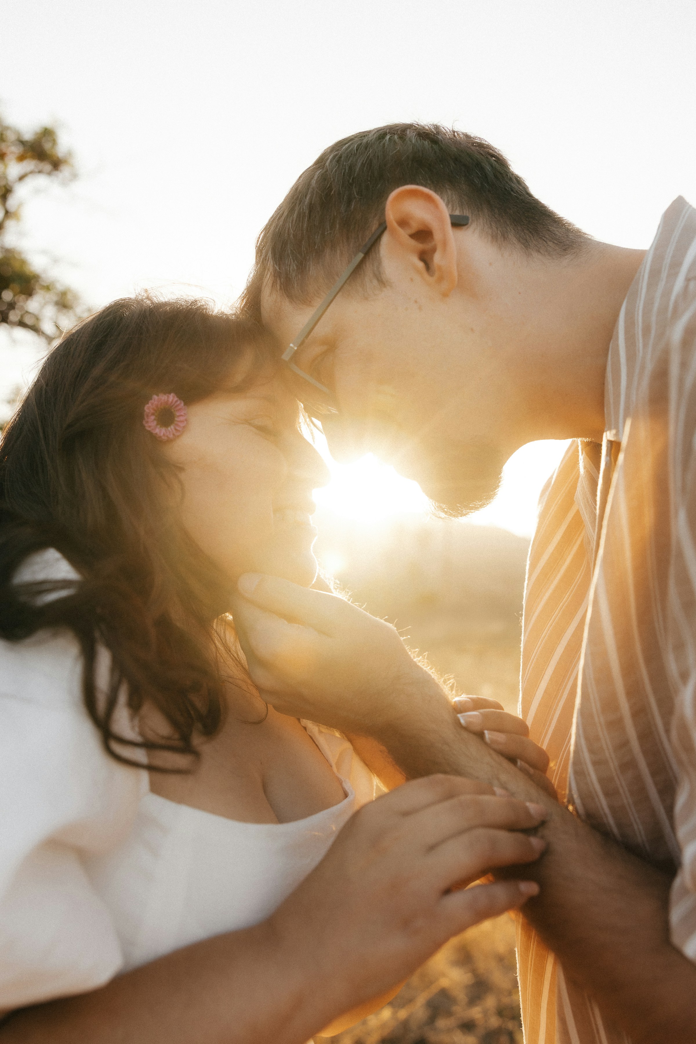 PLACEHOLDER (Unsplash) — couple embracing at sunset