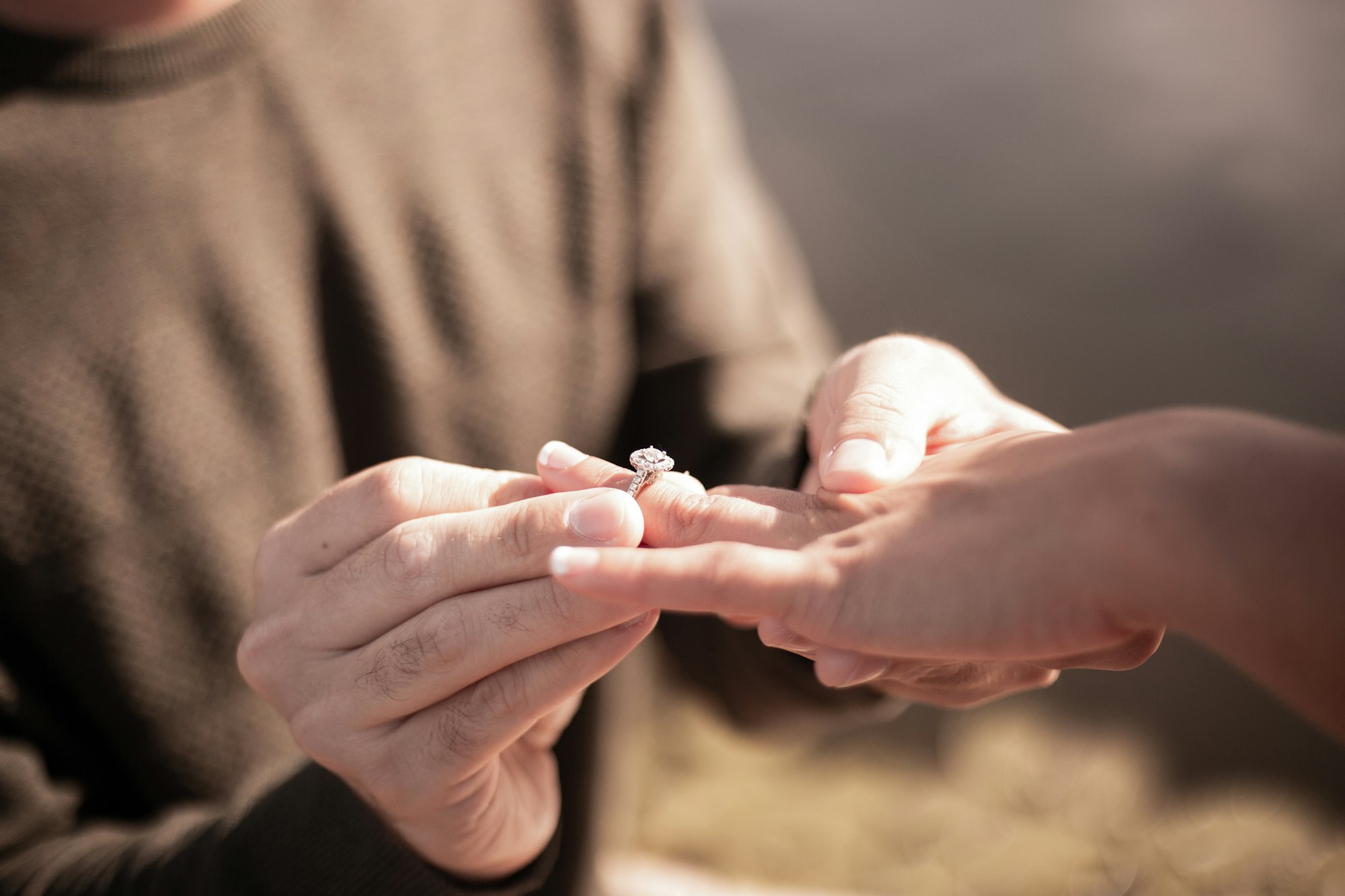 PLACEHOLDER (Unsplash) — hand holding a diamond ring