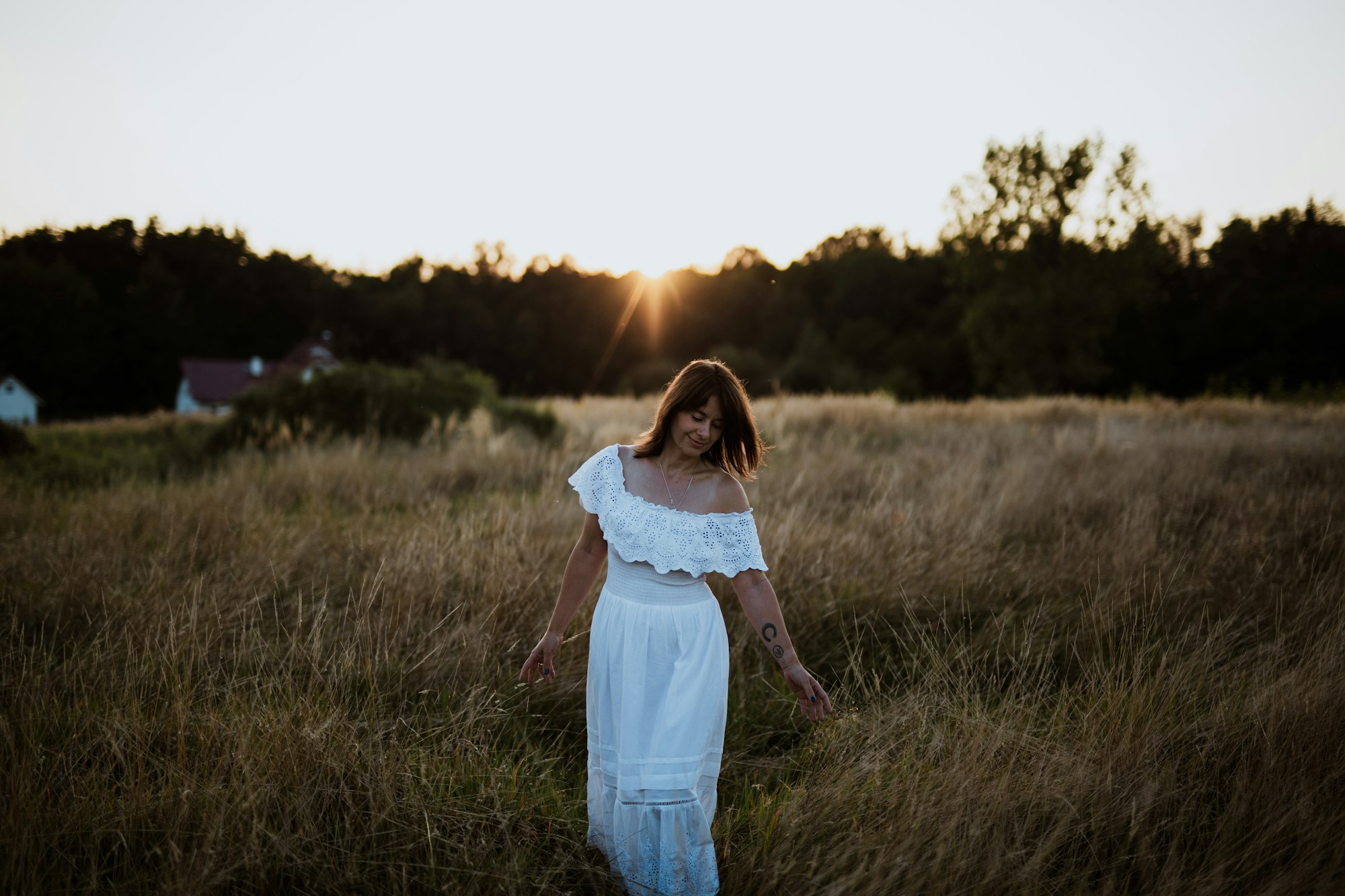 PLACEHOLDER (Unsplash) — woman in white dress walking through a golden field