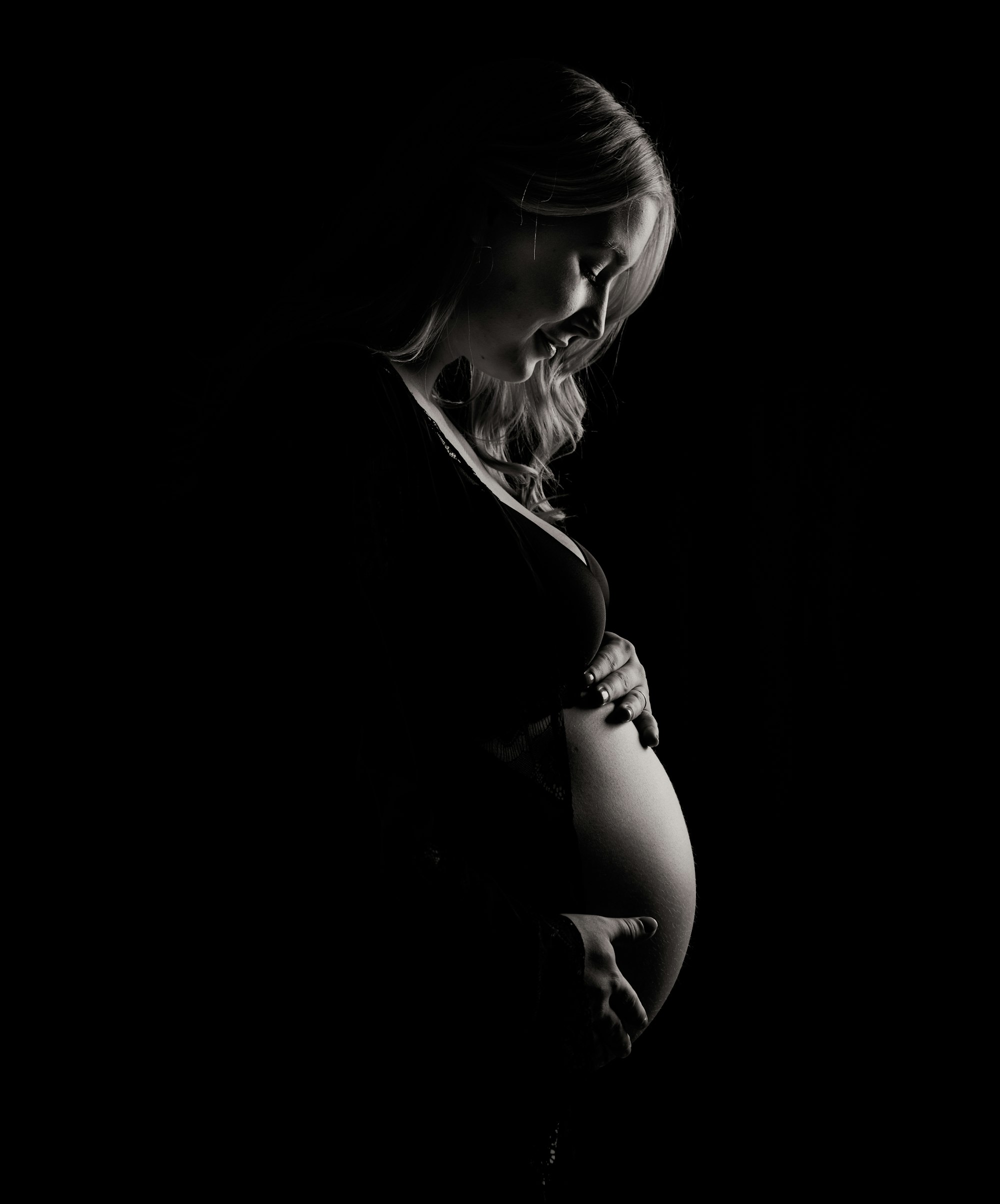PLACEHOLDER (Unsplash) — pregnant woman holding her belly