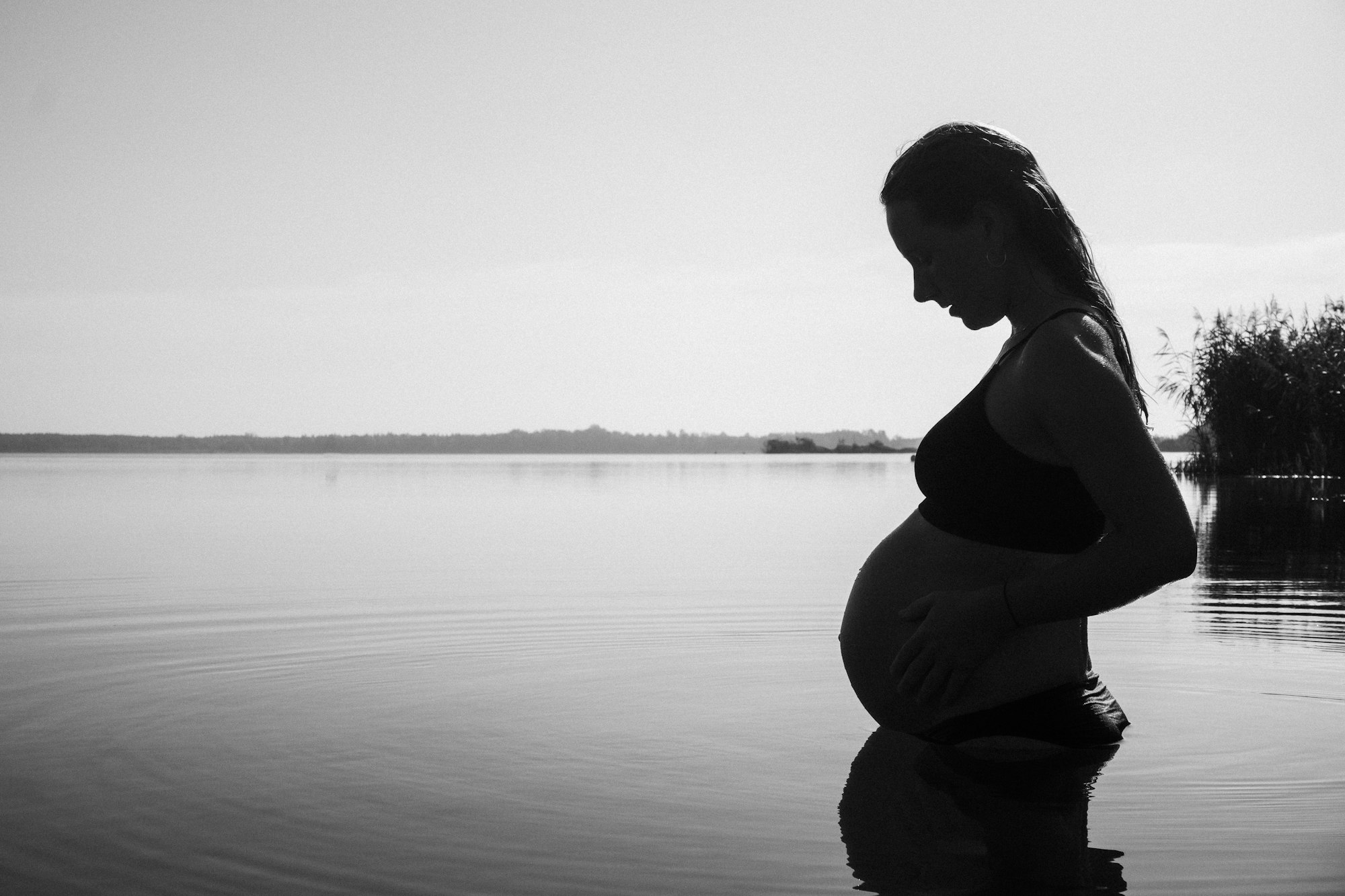 PLACEHOLDER (Unsplash) — pregnant woman standing in the water
