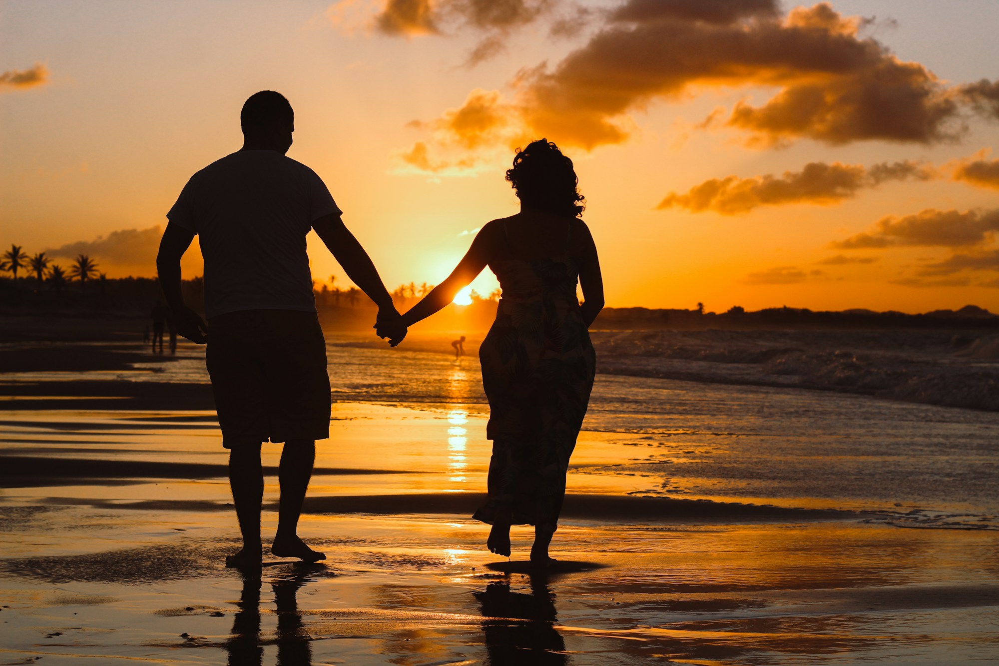 PLACEHOLDER (Unsplash) — couple standing by the water at golden hour