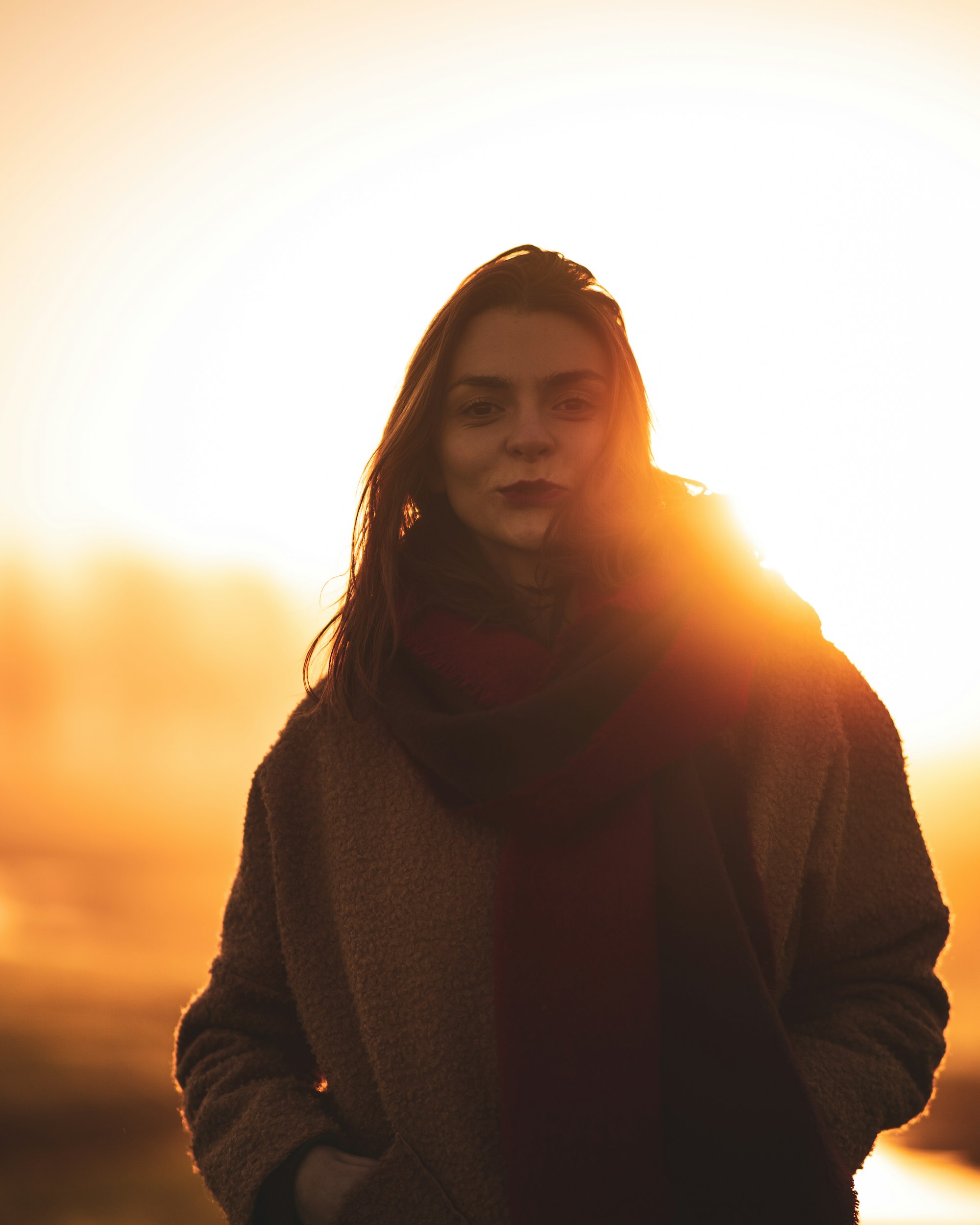 PLACEHOLDER (Unsplash) — woman in black sweater at sunset